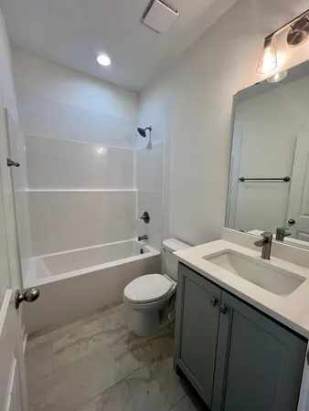 a kitchen with white cabinets and sink