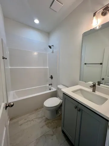 a kitchen with white cabinets and sink