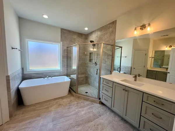 a bathroom with a double vanity sink tub and shower