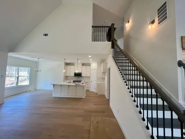 a view of kitchen and hall with wooden floor