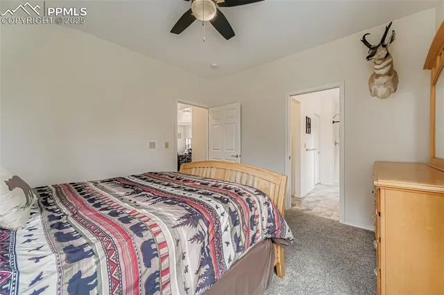 a bedroom with a bed and a refrigerator