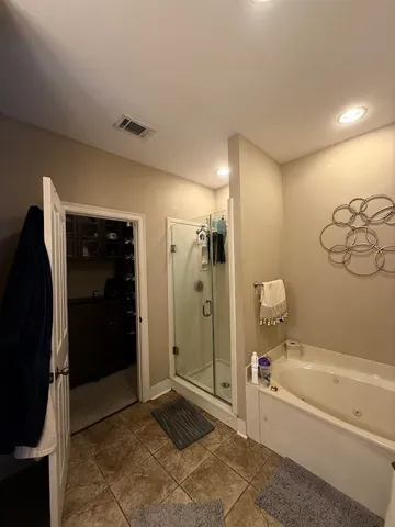a bathroom with a tub and shower