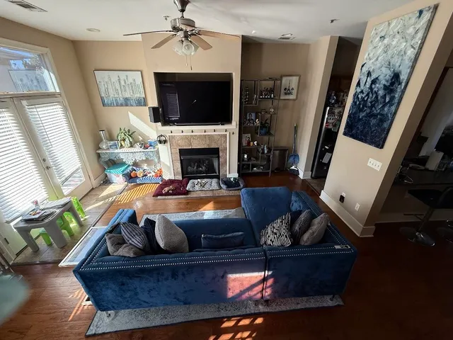 a living room with furniture and a chandelier