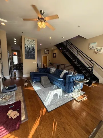 a living room with furniture and a chandelier