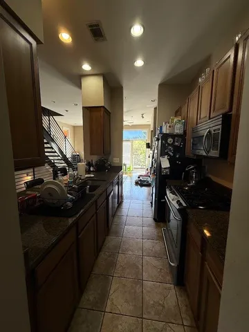 a kitchen with a sink appliances and cabinets