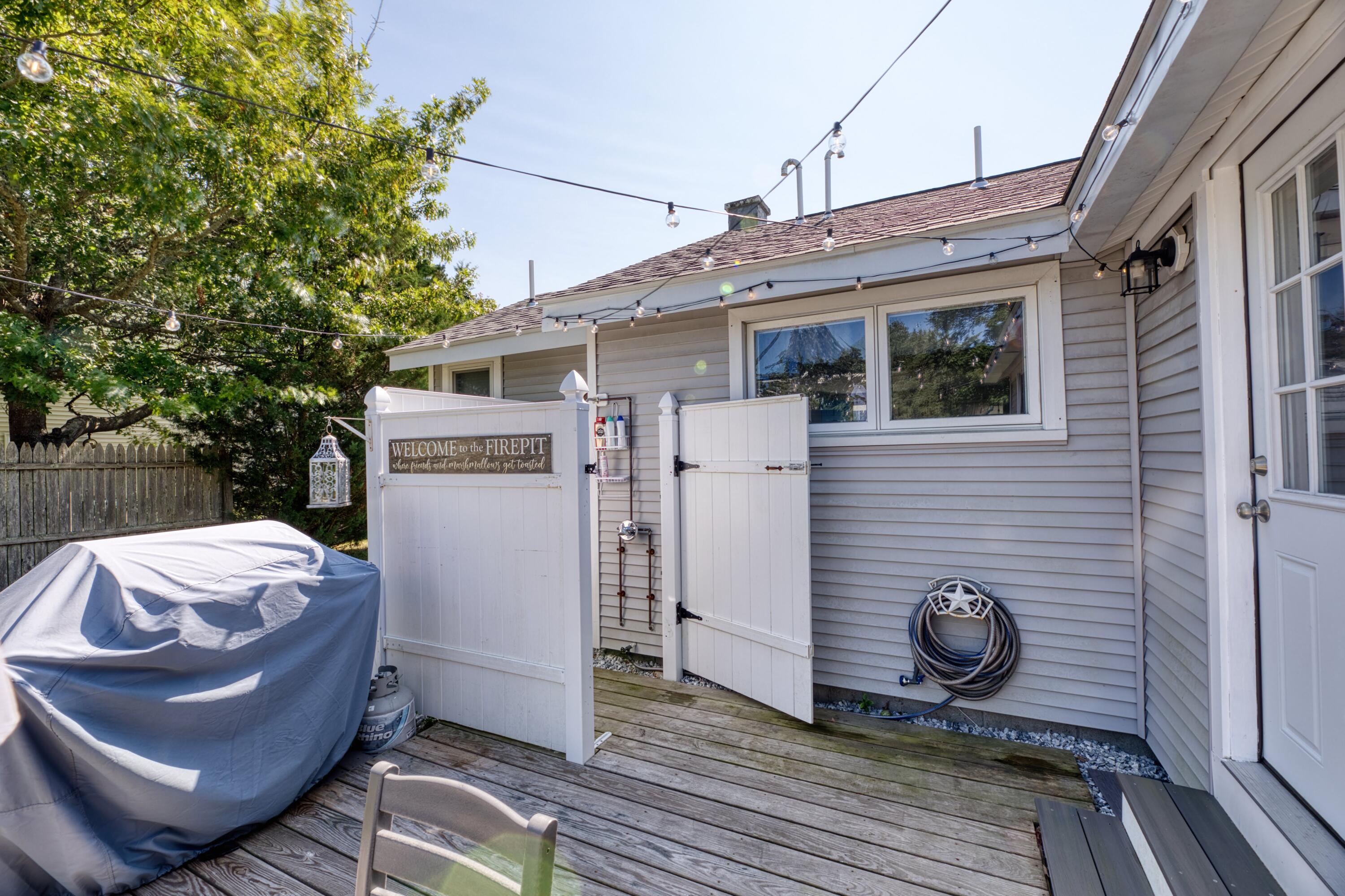 41 Bourne Neck Drive Buzzards Bay, MA 02532 - Photo 11 of 52 a view of a wooden deck and a backyard