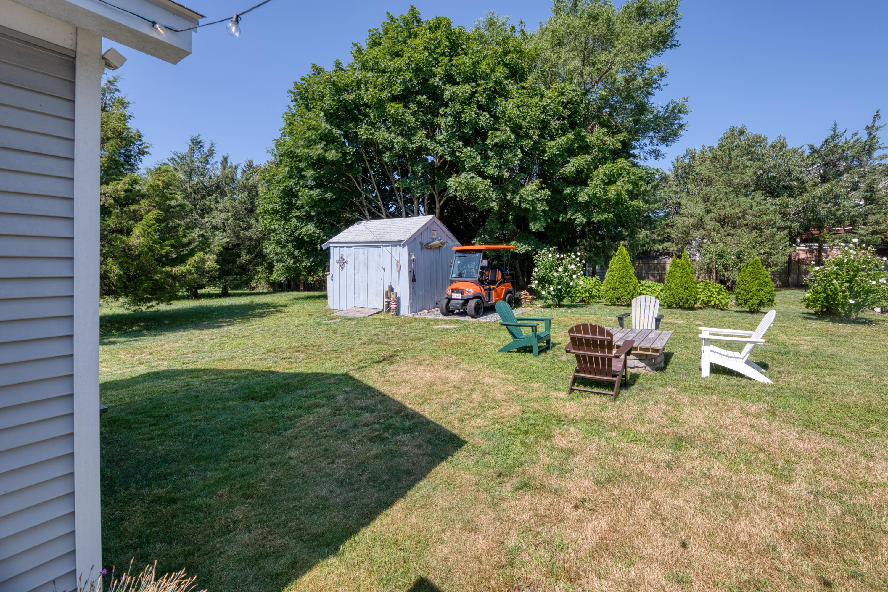 41 Bourne Neck Drive Buzzards Bay, MA 02532 - Photo 16 of 52 a view of a chairs and table in backyard of the house