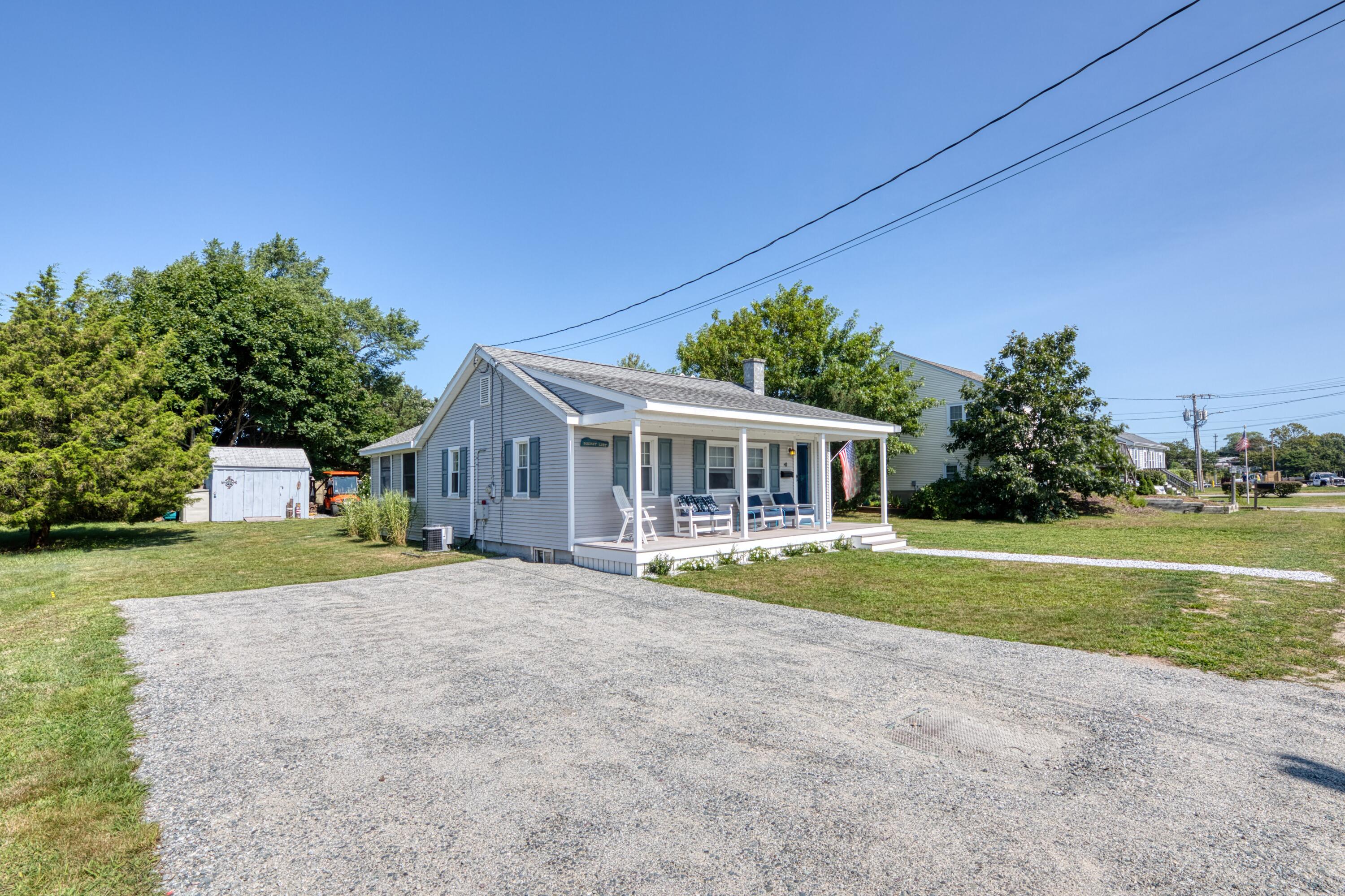 41 Bourne Neck Drive Buzzards Bay, MA 02532 - Photo 2 of 52 a front view of a house with a yard and trees