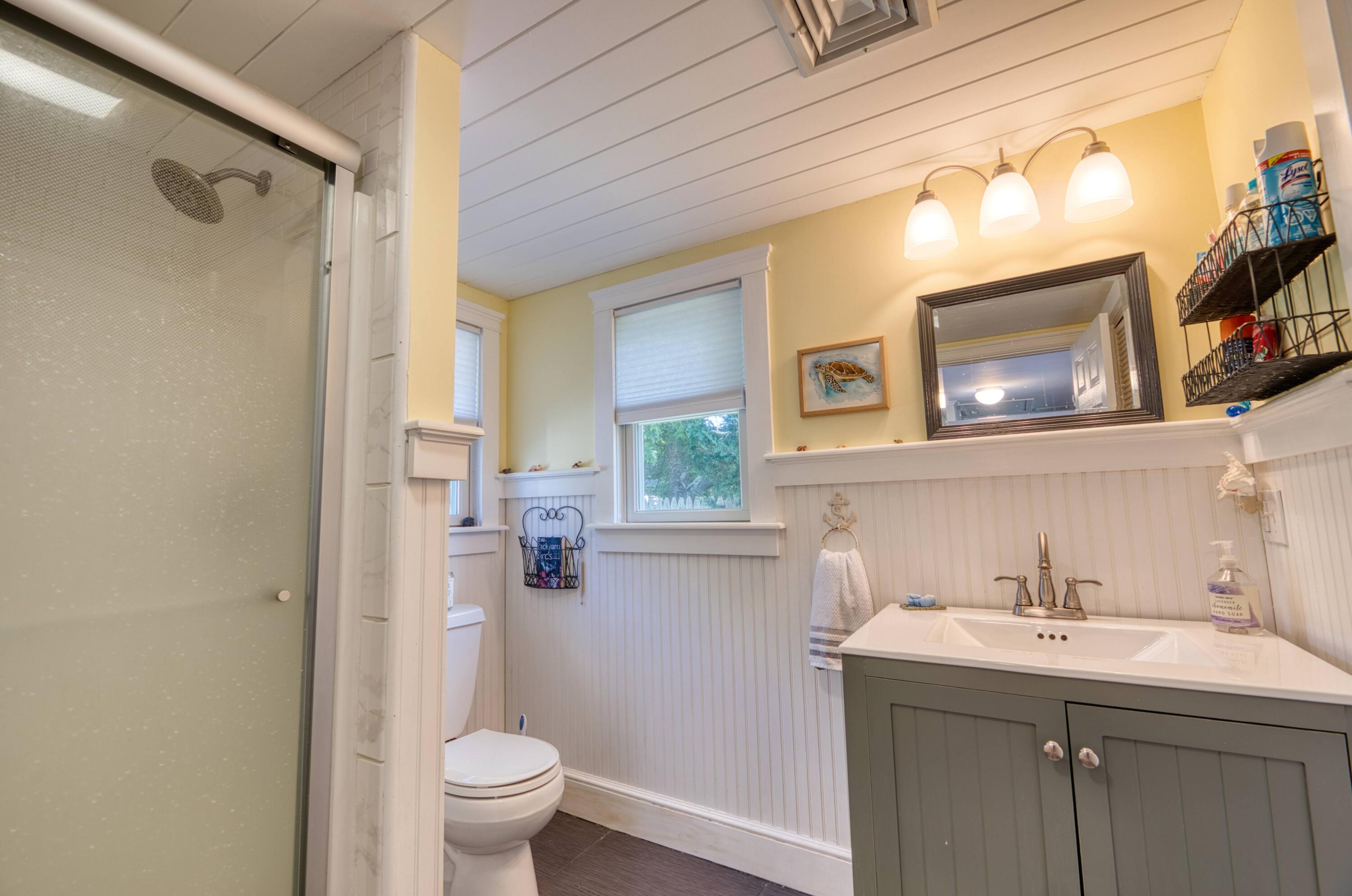 41 Bourne Neck Drive Buzzards Bay, MA 02532 - Photo 36 of 52 a bathroom with a sink and mirror with toilet