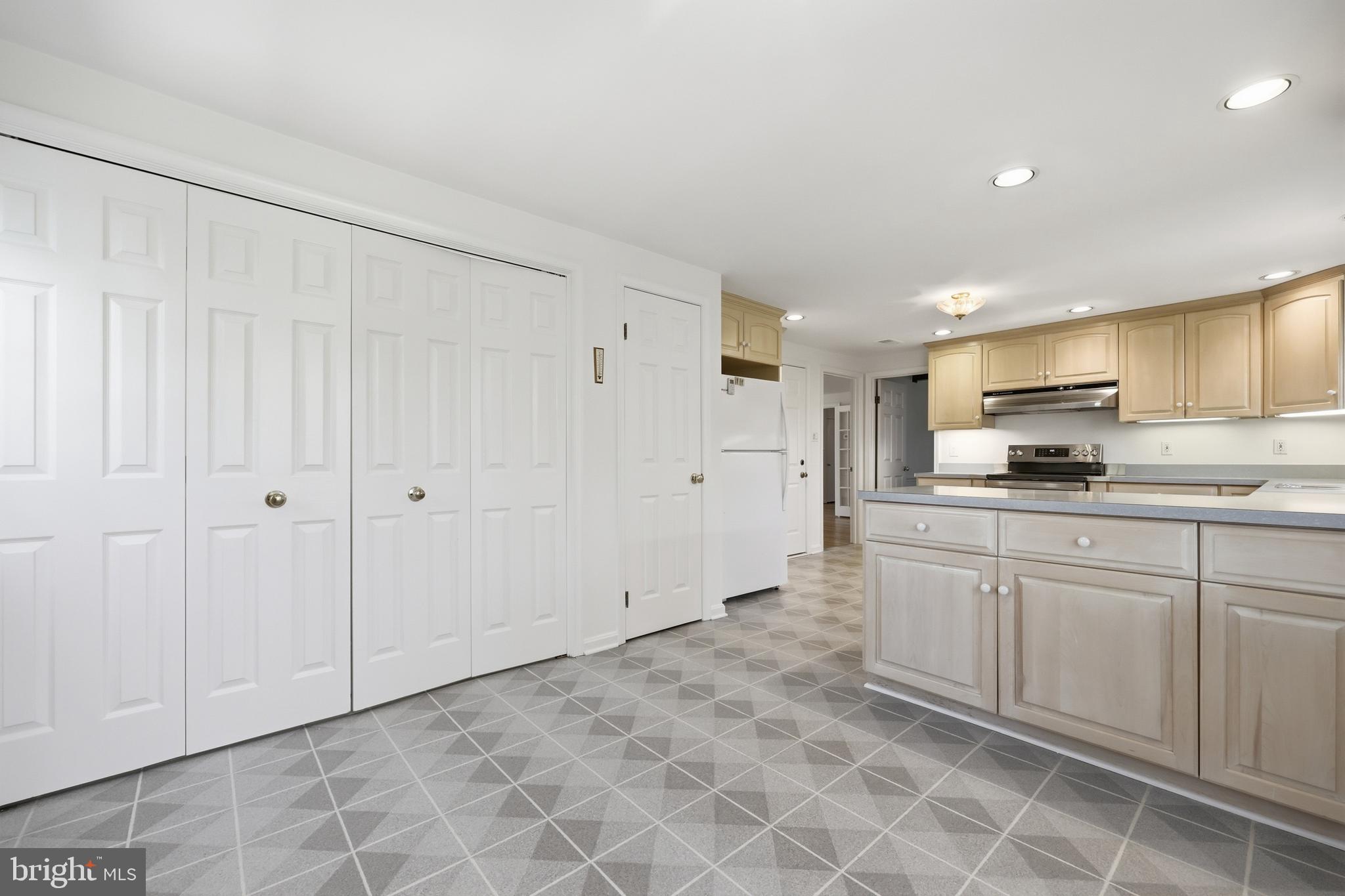 12428 Over Ridge Road Potomac, MD 20854 - Photo 29 of 81 a kitchen with granite countertop a sink white cabinets and stainless steel appliances