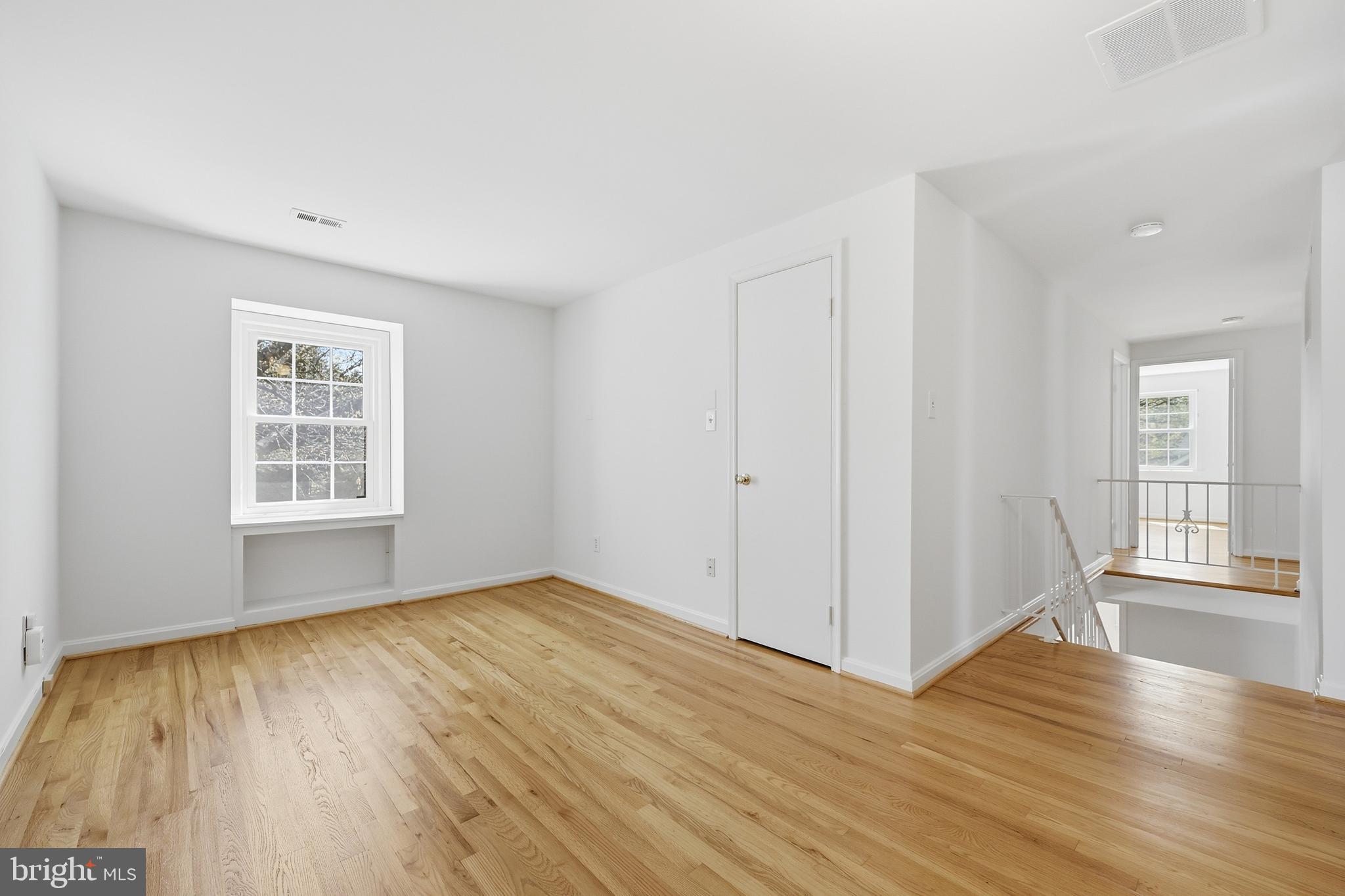 12428 Over Ridge Road Potomac, MD 20854 - Photo 41 of 81 a view of an empty room with wooden floor and a window