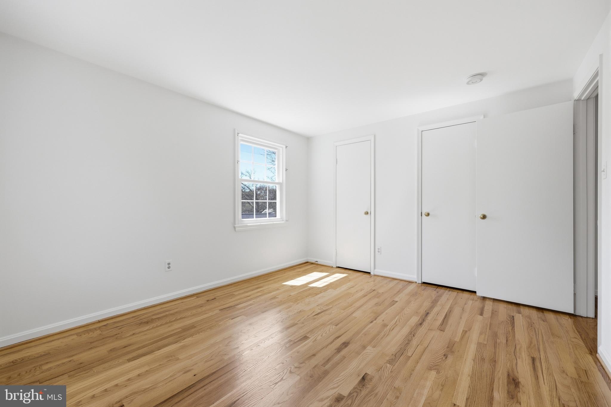 12428 Over Ridge Road Potomac, MD 20854 - Photo 54 of 81 a view of an empty room with wooden floor and a window