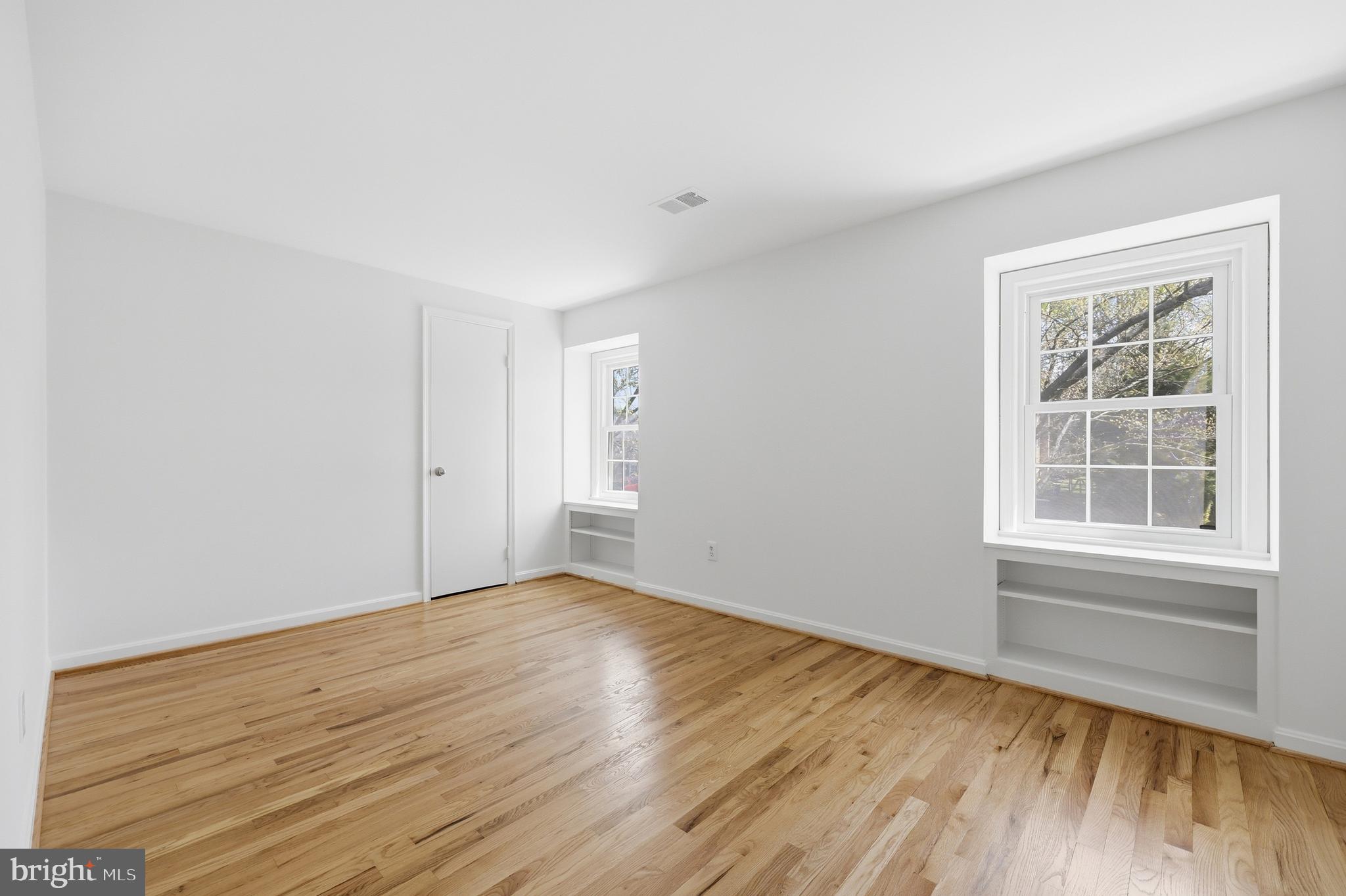 12428 Over Ridge Road Potomac, MD 20854 - Photo 55 of 81 an empty room with wooden floor and windows