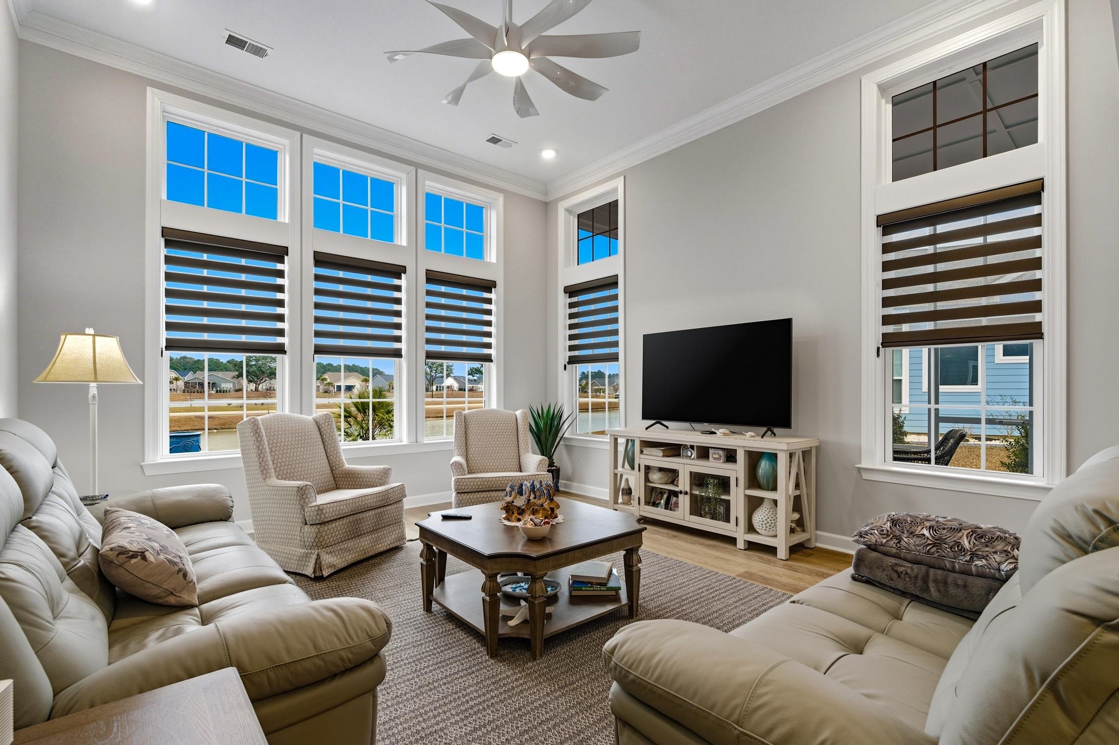 236 Bluestem Loop Little River, SC 29566 - Photo 12 of 40 Living area featuring crown molding, wood finished floors, a ceiling fan, healthy amount of natural light, and recessed lighting