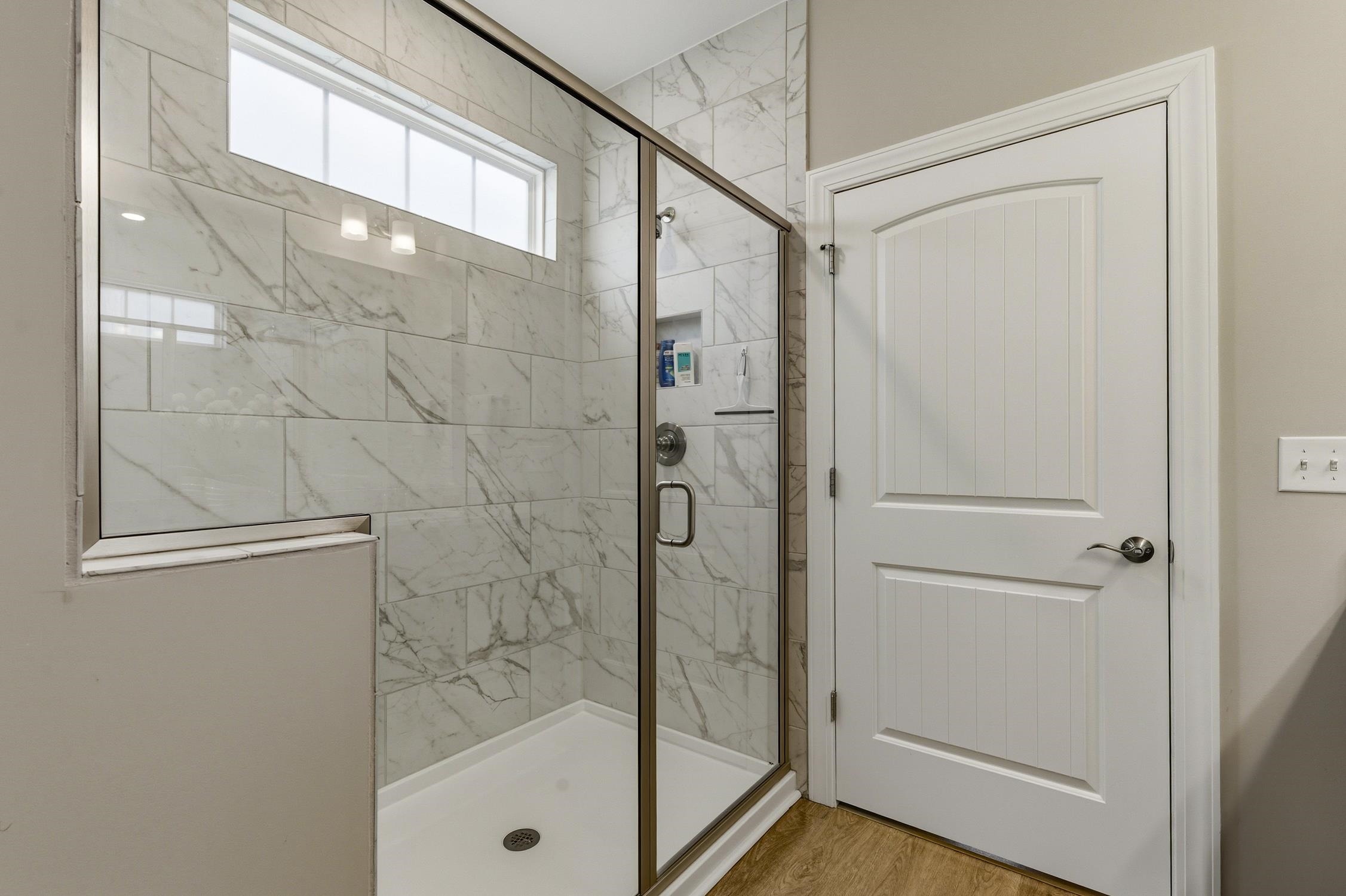 236 Bluestem Loop Little River, SC 29566 - Photo 18 of 40 Bathroom featuring a marble finish shower and wood finished floors