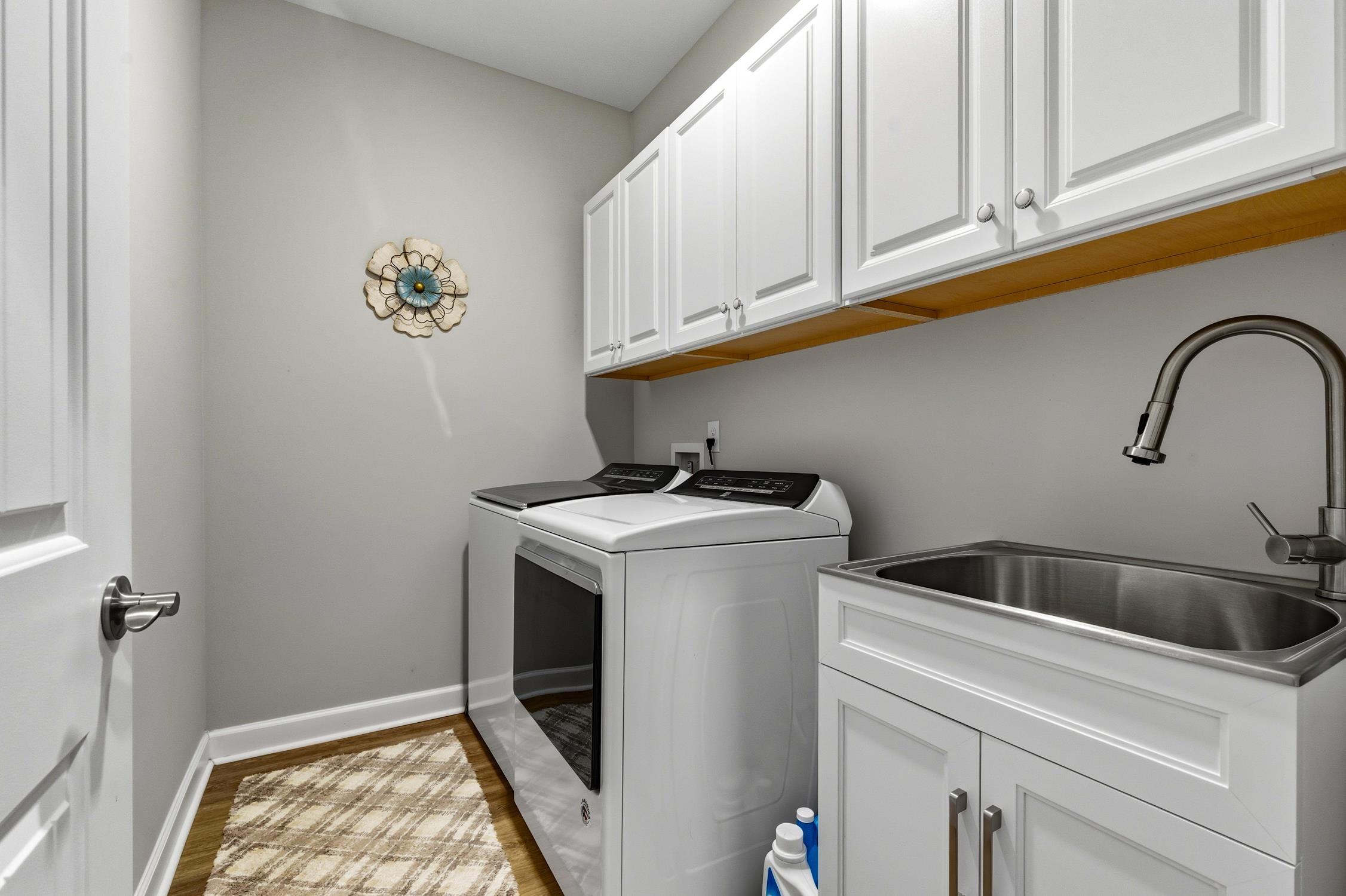 236 Bluestem Loop Little River, SC 29566 - Photo 21 of 40 Laundry room featuring cabinet space, independent washer and dryer, and light wood finished floors