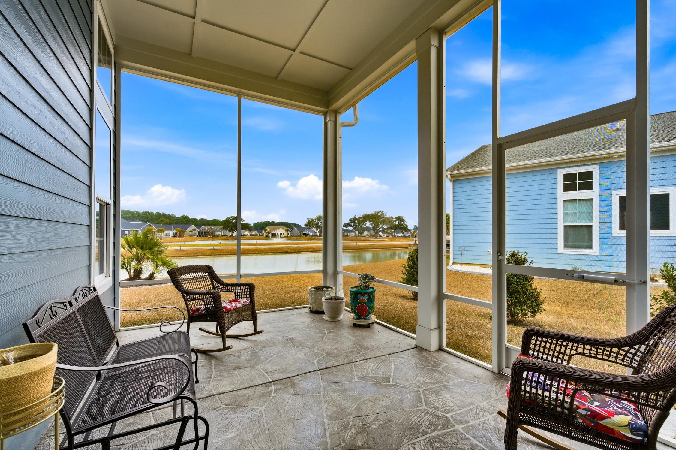 236 Bluestem Loop Little River, SC 29566 - Photo 3 of 40 Sunroom / solarium featuring a water view, healthy amount of natural light, and stone finish flooring