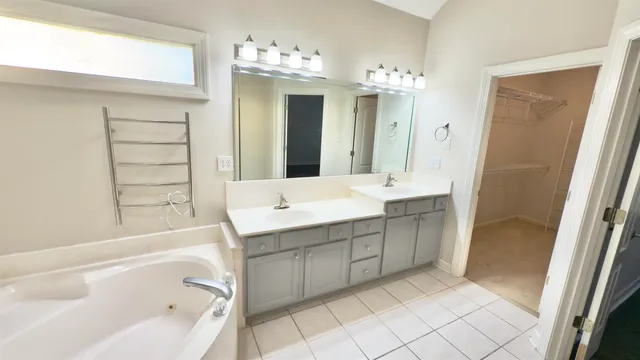 a bathroom with a double vanity sink toilet and shower
