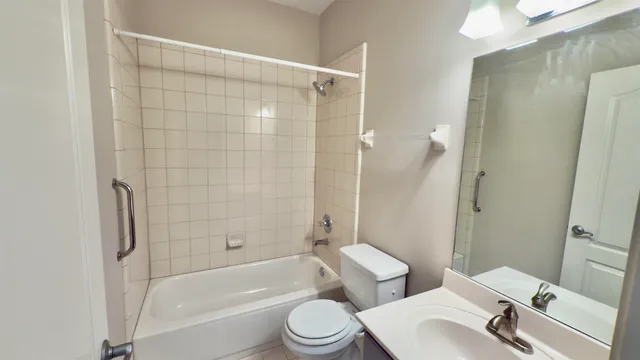 an empty room with wooden floor fan and window
