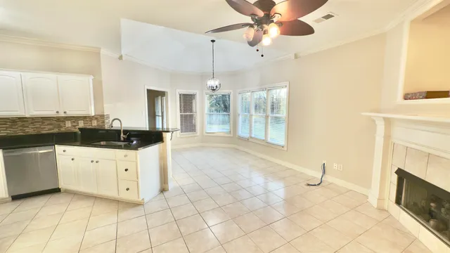 a view of a livingroom with furniture and a ceiling fan