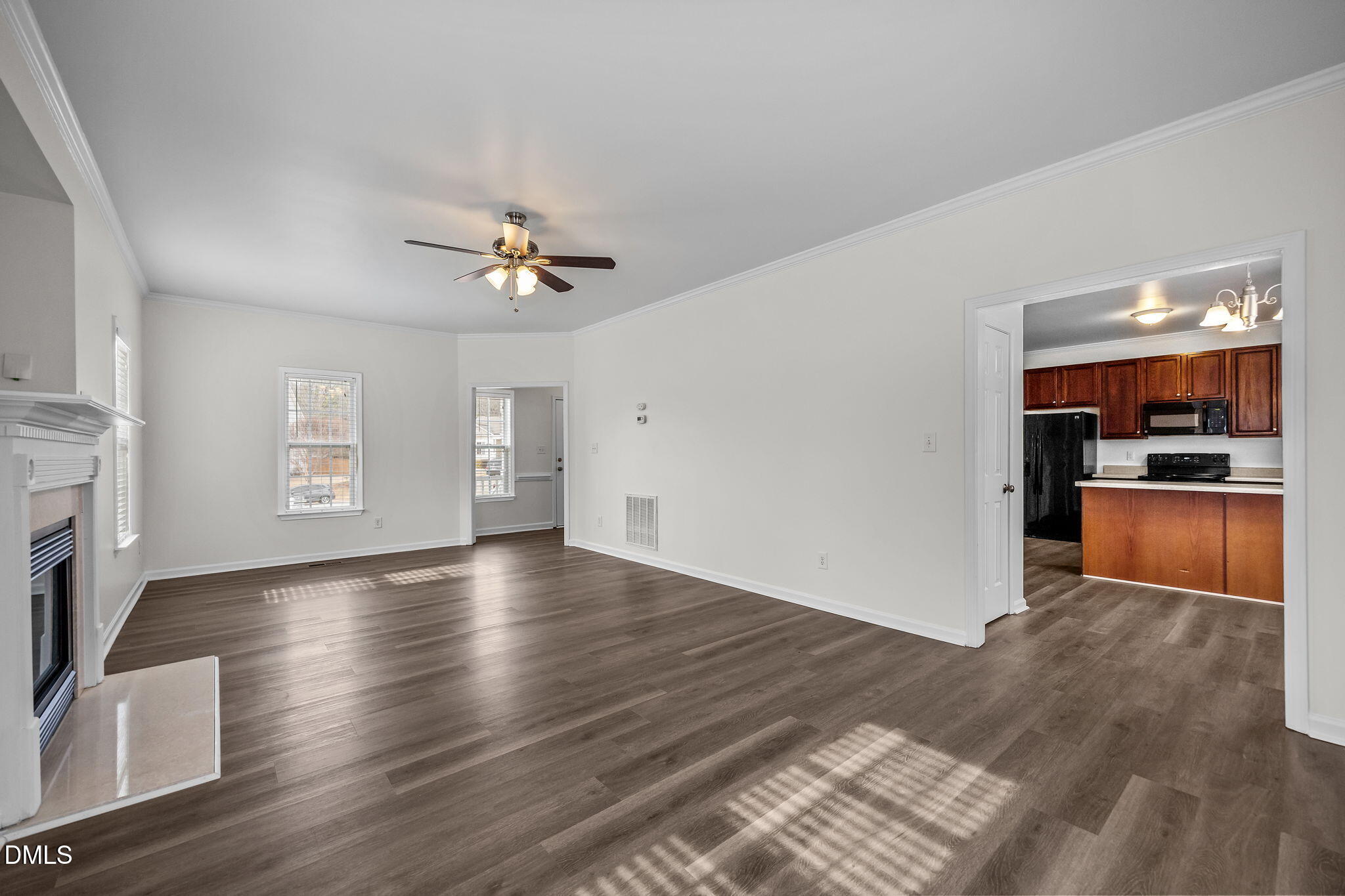 1305 Tawny View Lane Raleigh, NC 27603 - Photo 11 of 47 a view of an empty room with wooden floor and a kitchen