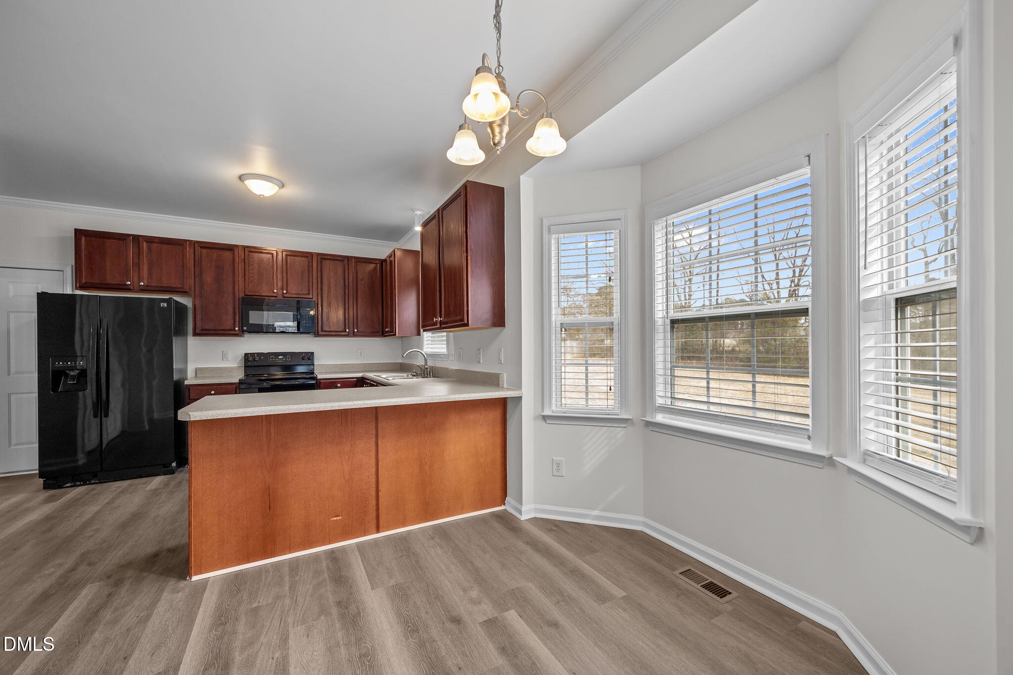 1305 Tawny View Lane Raleigh, NC 27603 - Photo 12 of 47 a kitchen with stainless steel appliances granite countertop a refrigerator a sink dishwasher a stove and a dining table with wooden floor