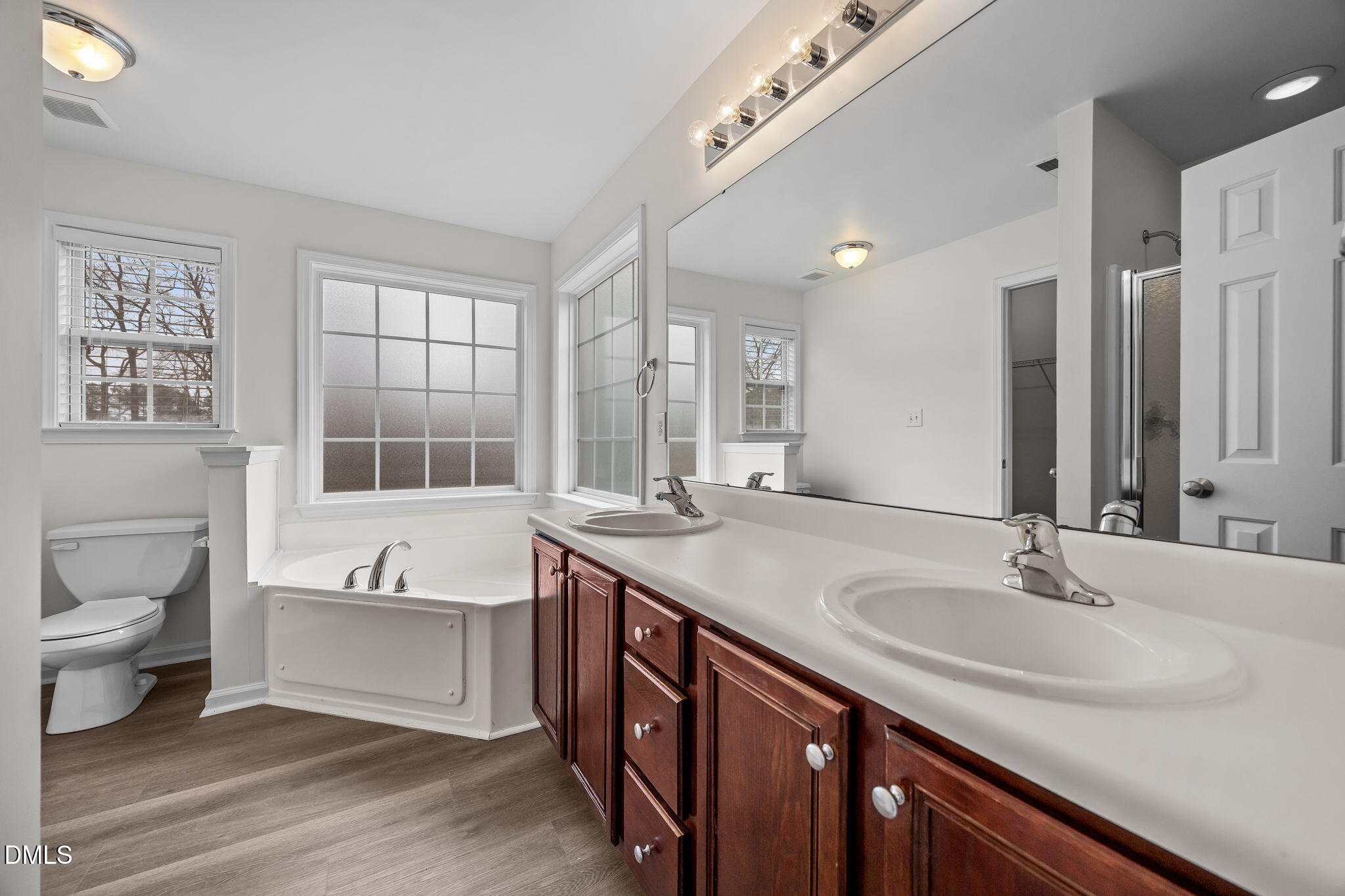 1305 Tawny View Lane Raleigh, NC 27603 - Photo 25 of 47 a spacious bathroom with a double vanity sink a mirror and a bathtub