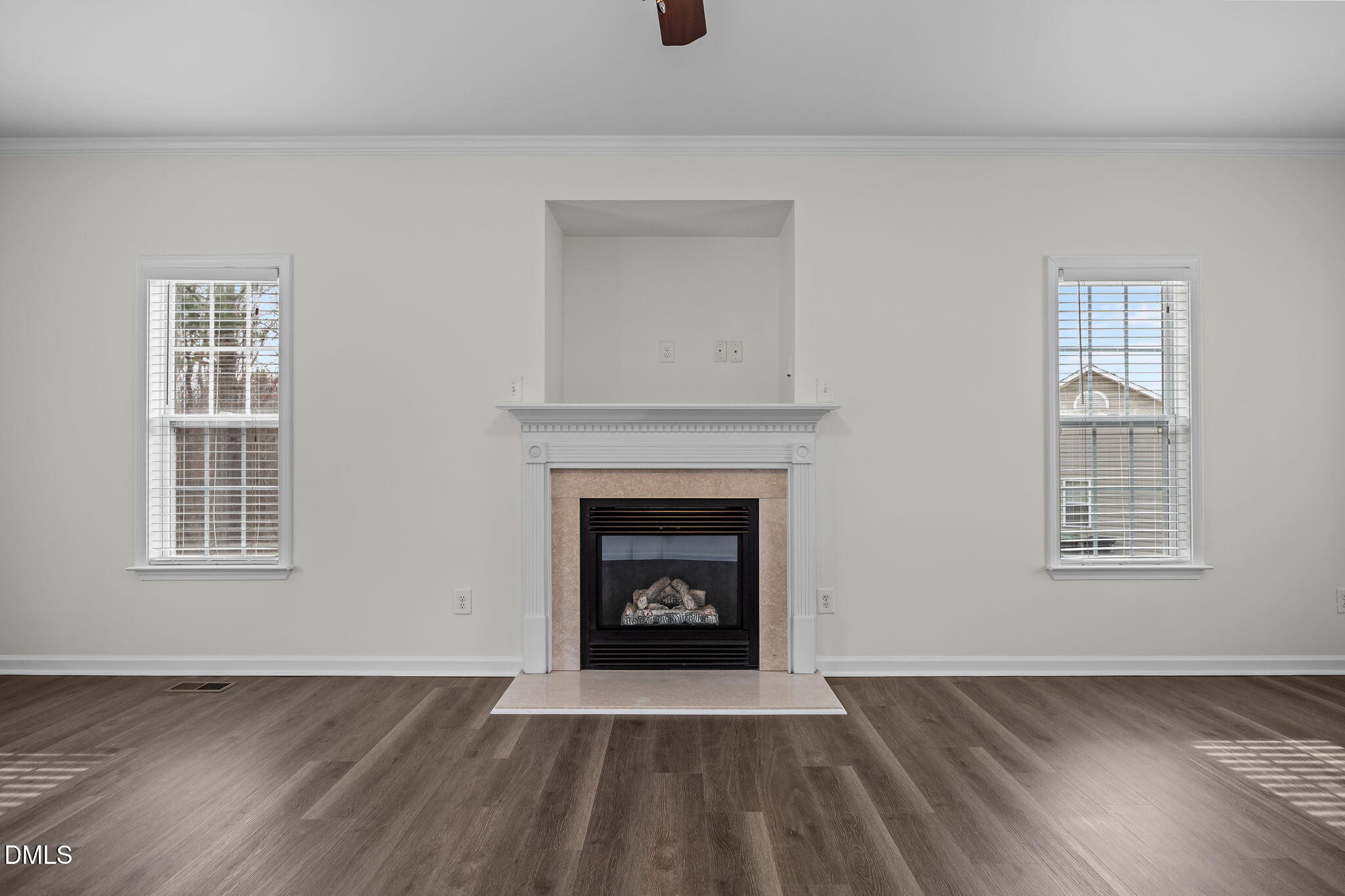 1305 Tawny View Lane Raleigh, NC 27603 - Photo 9 of 47 a view of an empty room with wooden floor fireplace and a window