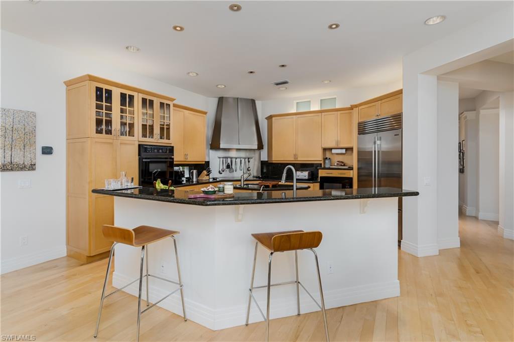 1150 Dimock Lane Naples, FL 34110 - Photo 20 of 40 a kitchen with stainless steel appliances granite countertop a sink and a refrigerator