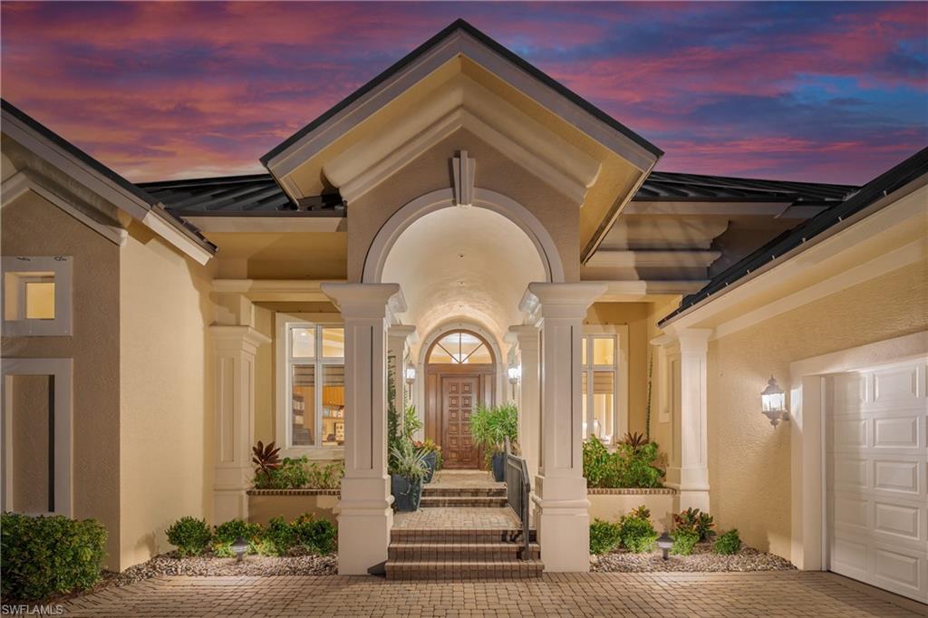 1150 Dimock Lane Naples, FL 34110 - Photo 2 of 40 a front view of a house with a garden