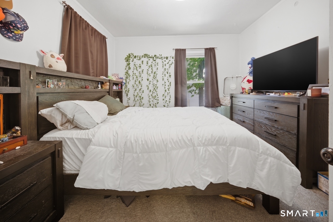 12 Webster Street Vernon, CT 06066 - Photo 12 of 33 a bedroom with a bed and flat screen tv