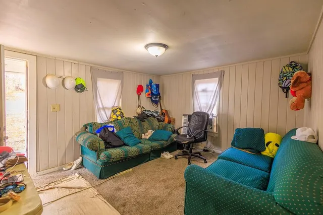 a living room with furniture rug and a window