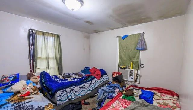 a bedroom with a bed and a window