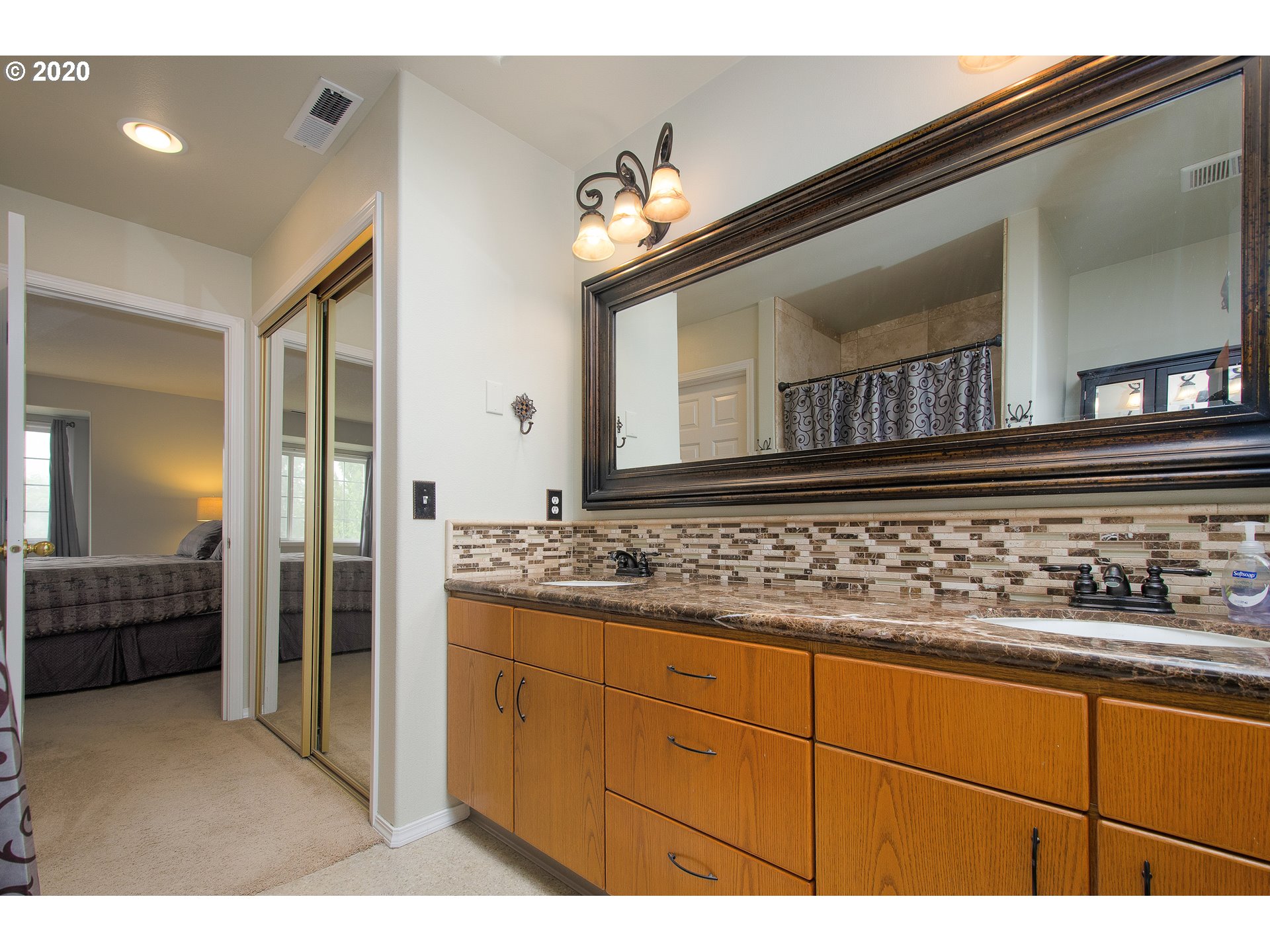 2415 Northeast 165th Street Ridgefield, WA 98642 - Photo 15 of 32 a bathroom with a sink a light fixture and a mirror