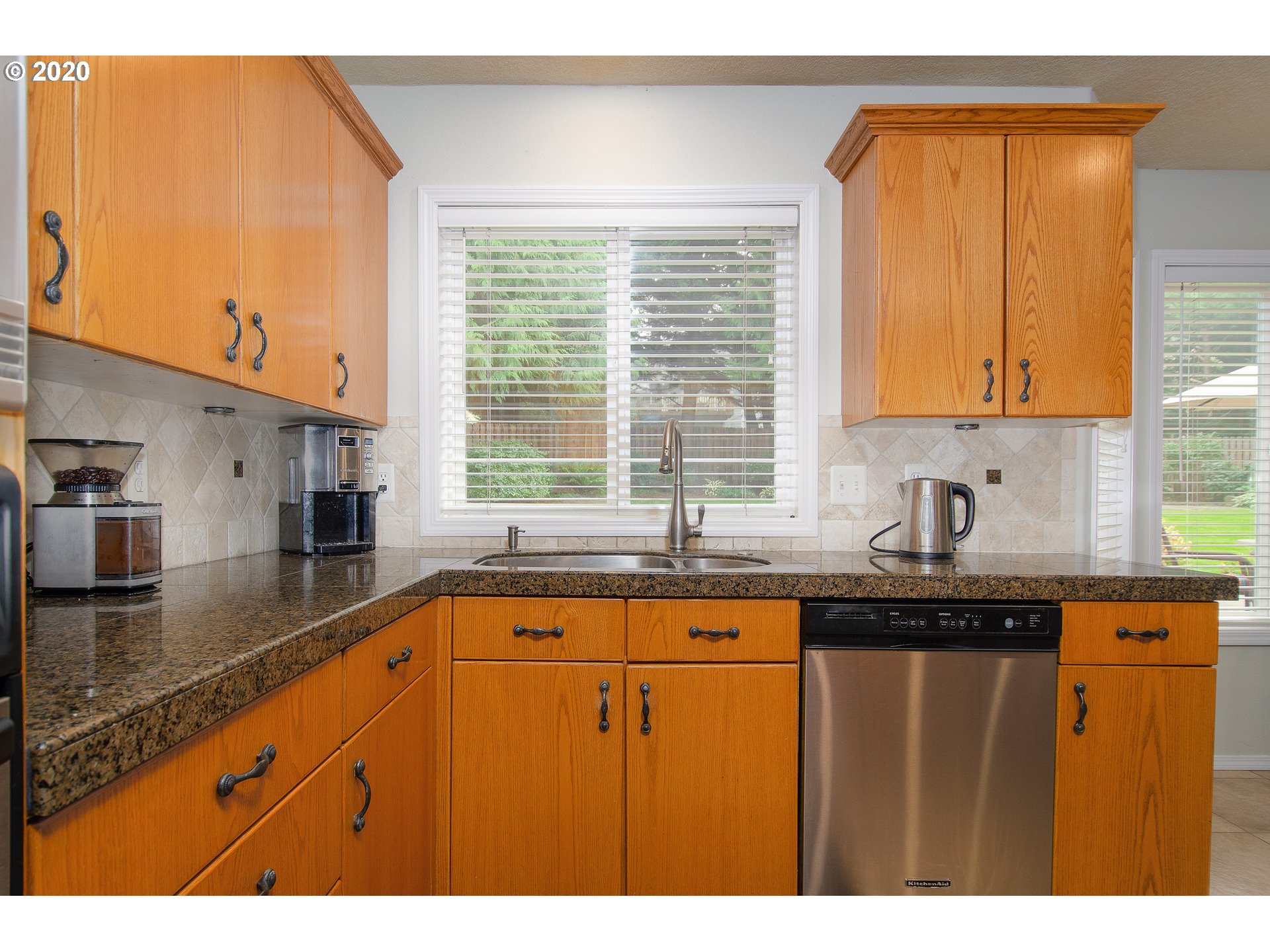 2415 Northeast 165th Street Ridgefield, WA 98642 - Photo 8 of 32 a kitchen with granite countertop a sink a window and stainless steel appliances