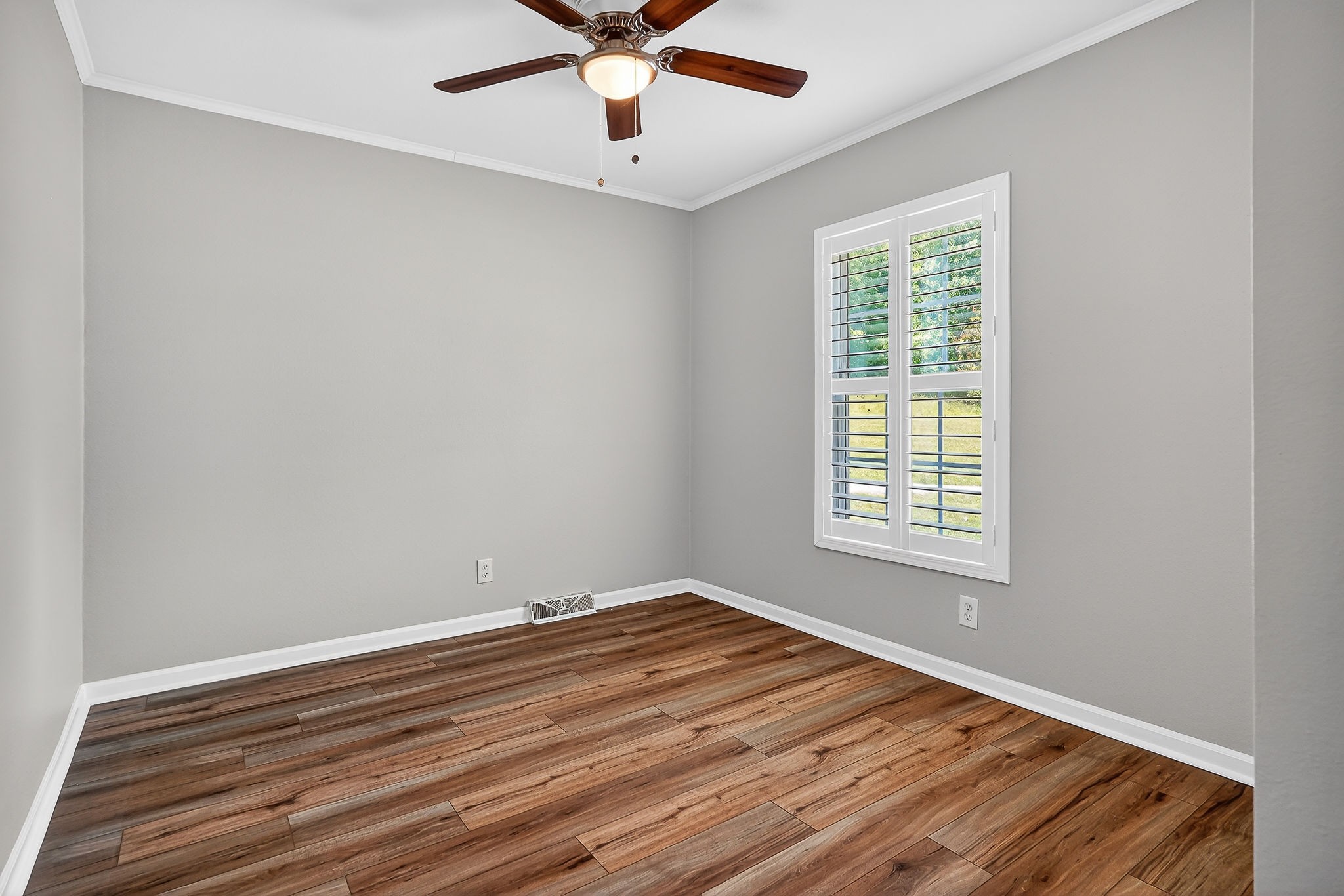 16130 Buffalo Valley Road Silver Point, TN 38582 - Photo 38 of 47 an empty room with wooden floor chandelier fan and windows