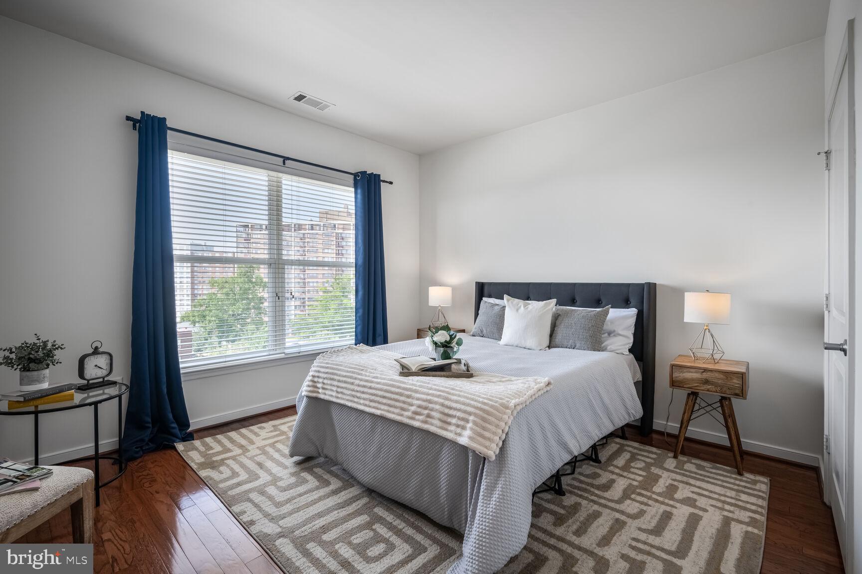 8045 Newell Street, Unit 516 Silver Spring, MD 20910 - Photo 15 of 33 a bedroom with a large bed and a window