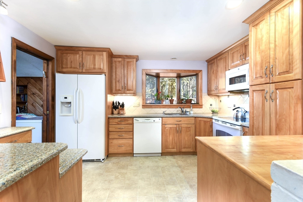 76 Joseph Road Framingham, MA 01701 - Photo 8 of 24 a kitchen with stainless steel appliances granite countertop a stove a sink and a refrigerator