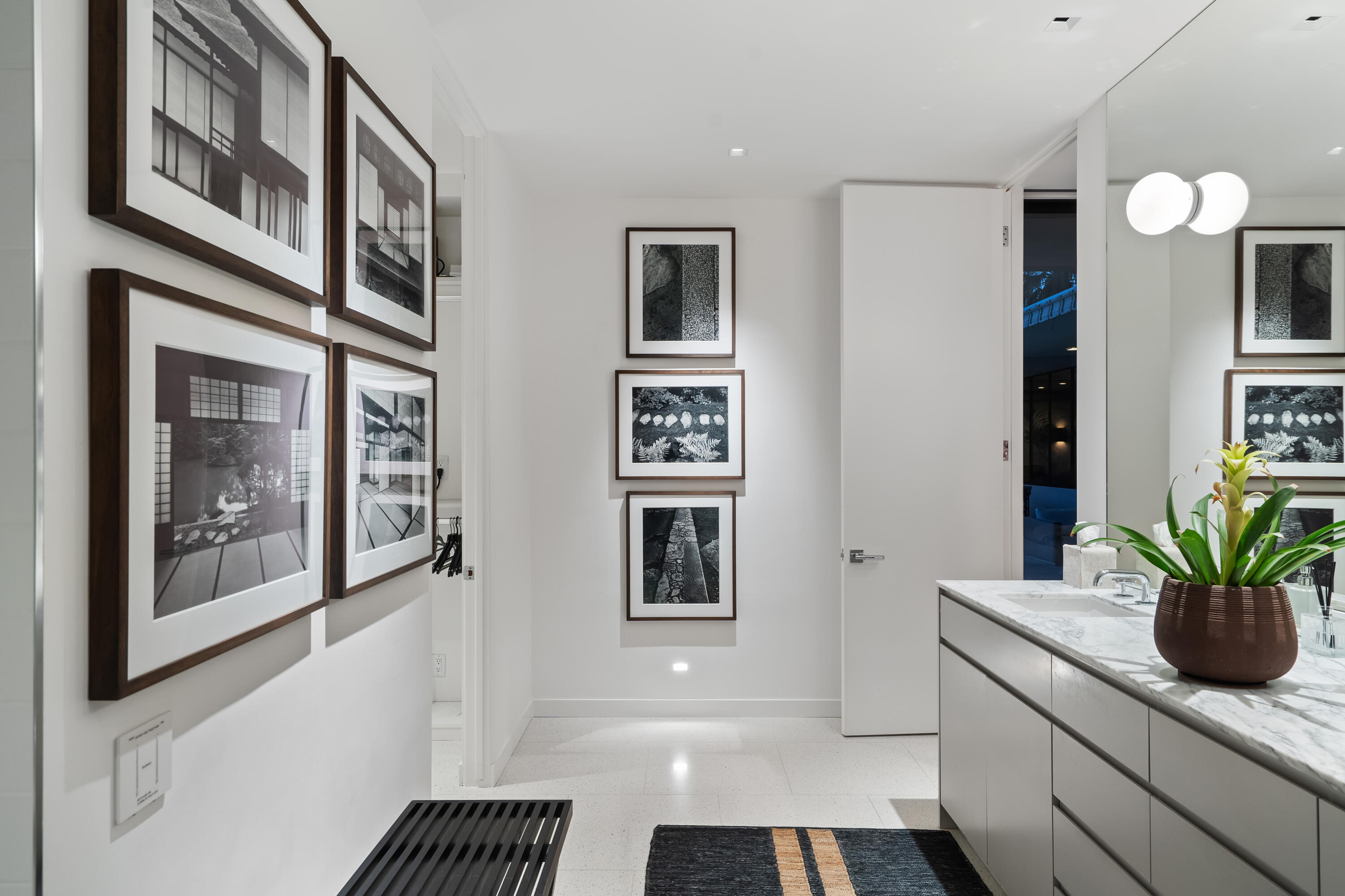 70149 Sonora Road Rancho Mirage, CA 92270 - Photo 26 of 48 a hallway with a potted plant on a counter top and a potted plant