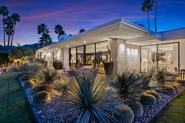 a view of a patio with table and chairs and potted plants
