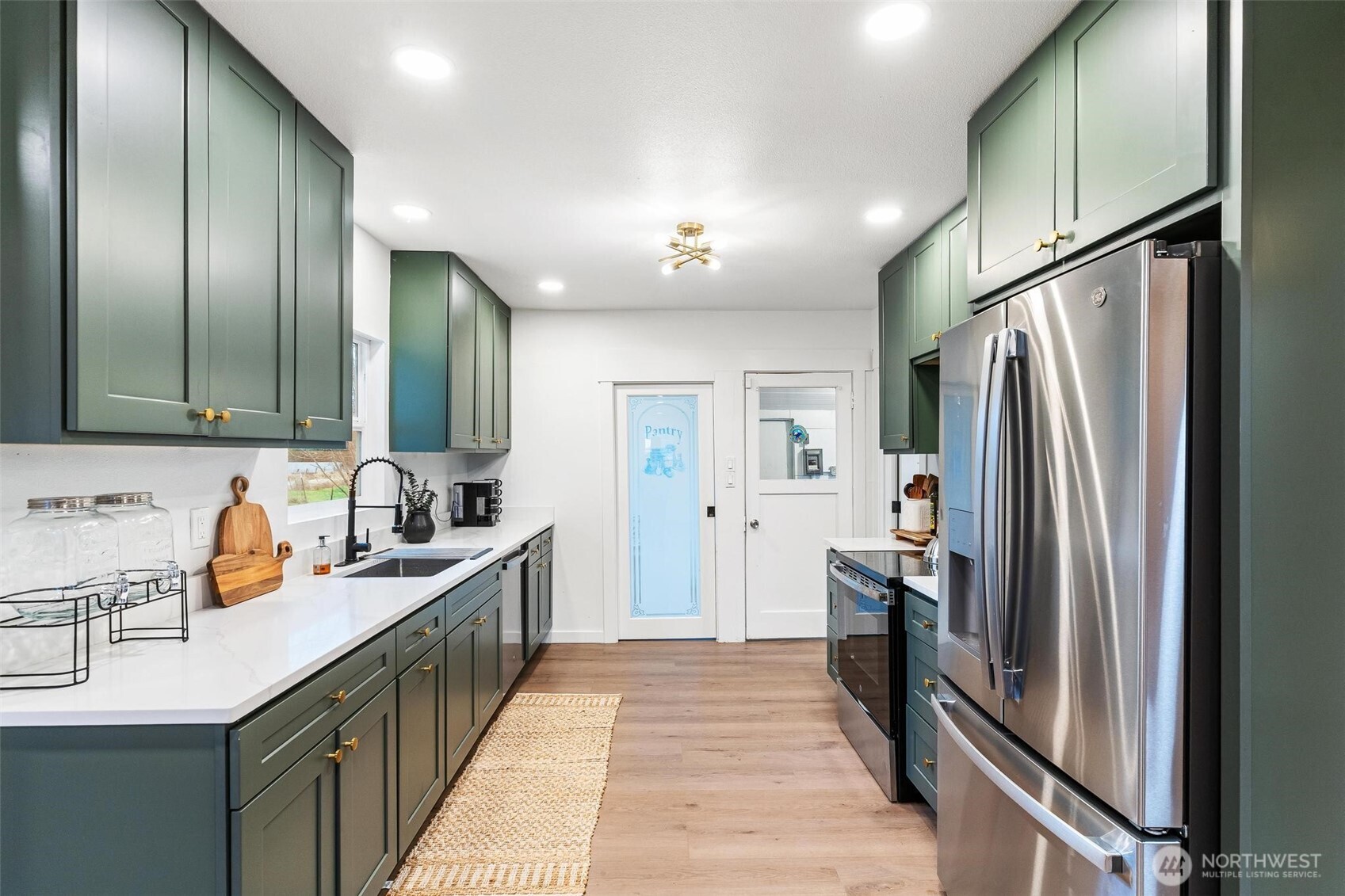 27805 Hinkleman Road East Buckley, WA 98321 - Photo 10 of 40 a kitchen with stainless steel appliances a sink stove and refrigerator