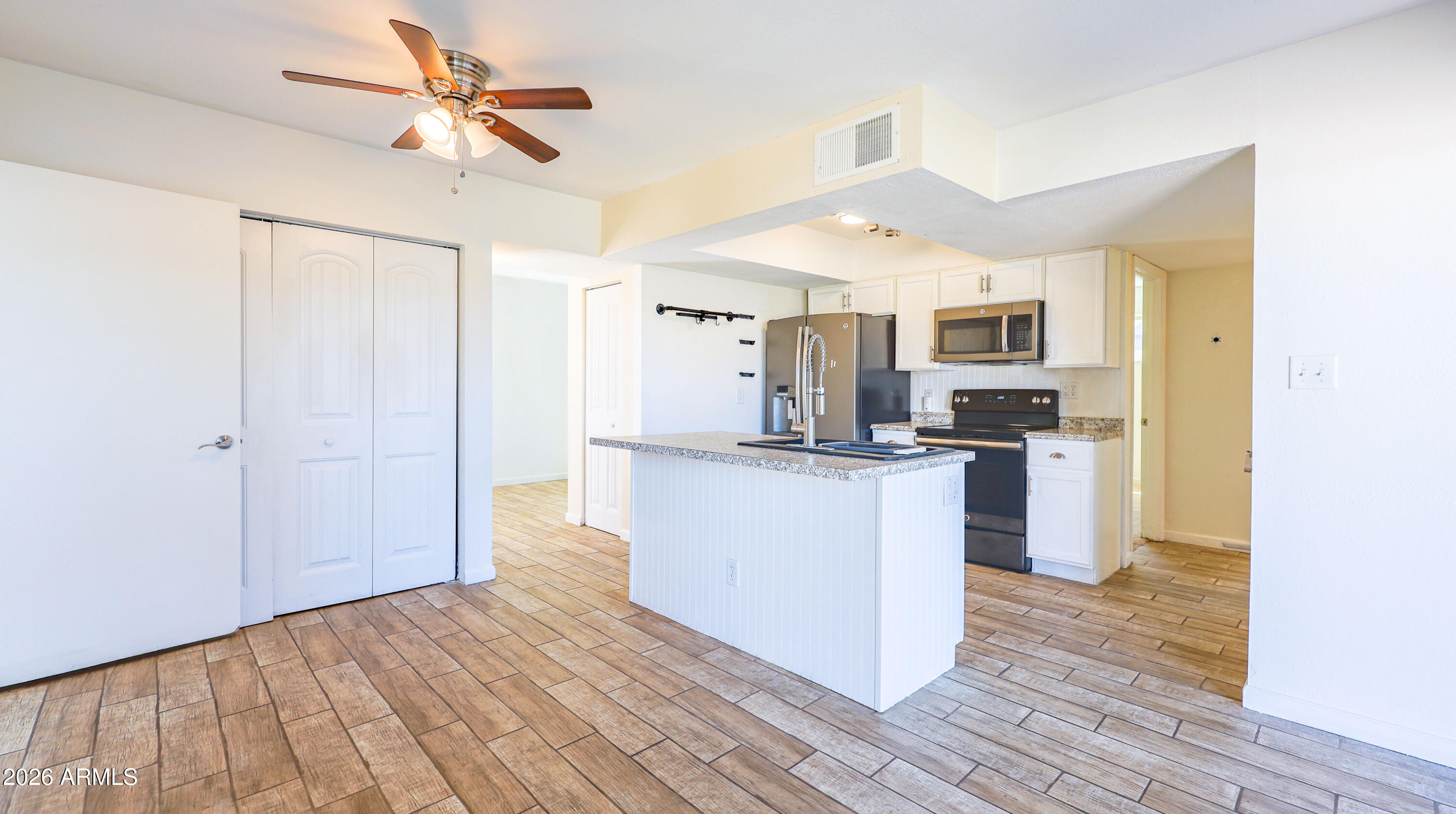 520 South 3rd Street Sierra Vista, AZ 85635 - Photo 7 of 28 a kitchen with kitchen island a sink and wooden floor