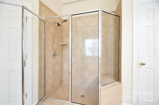 a bathroom with a glass shower door