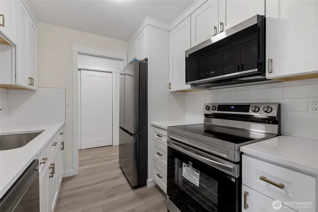 a kitchen with a stove and a microwave