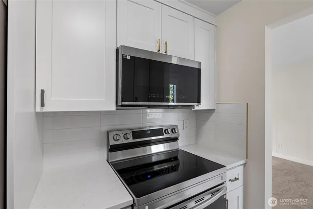 a kitchen with a stove and a microwave