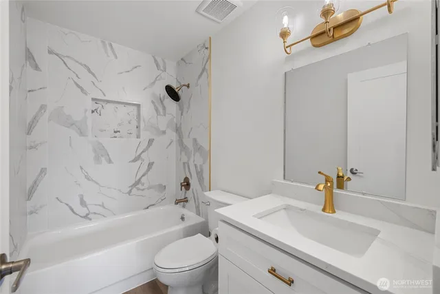 a bathroom with a sink a toilet and a bathtub