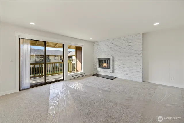 a view of an empty room with glass door and balcony