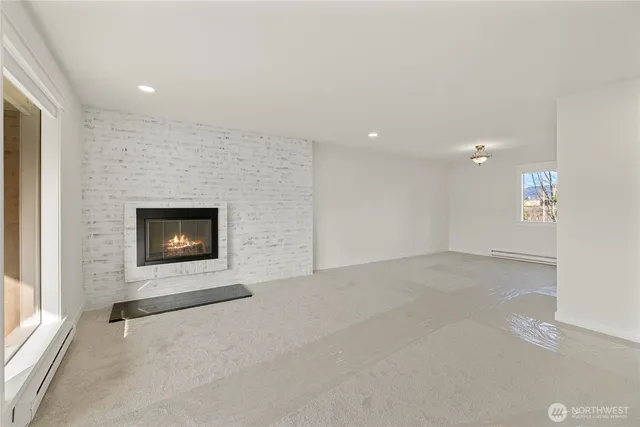 an empty room with a fireplace and a window