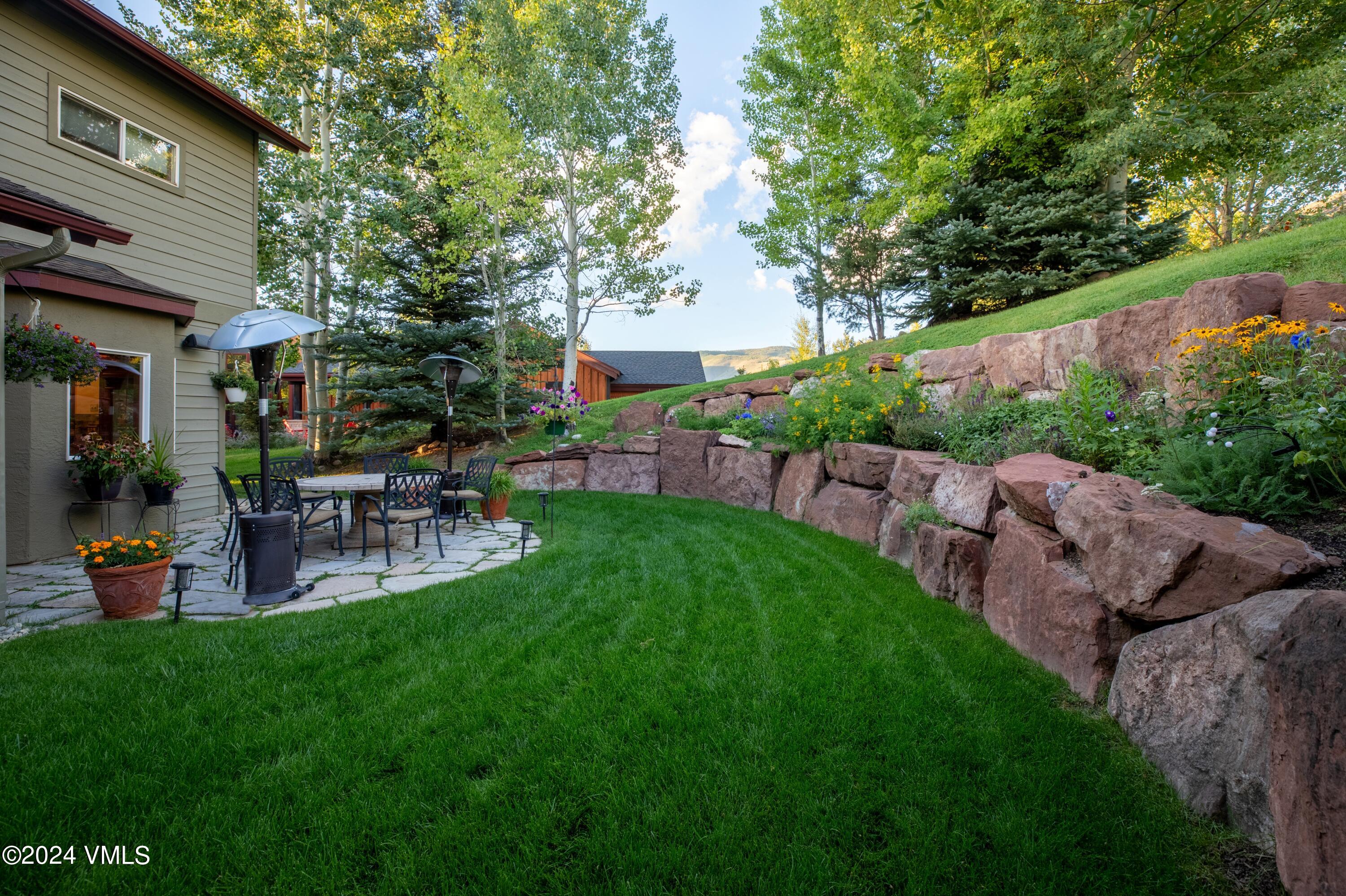 46 Andover Trail, Unit A Edwards, CO 81632 - Photo 22 of 27 a view of backyard of house with outdoor seating and green space