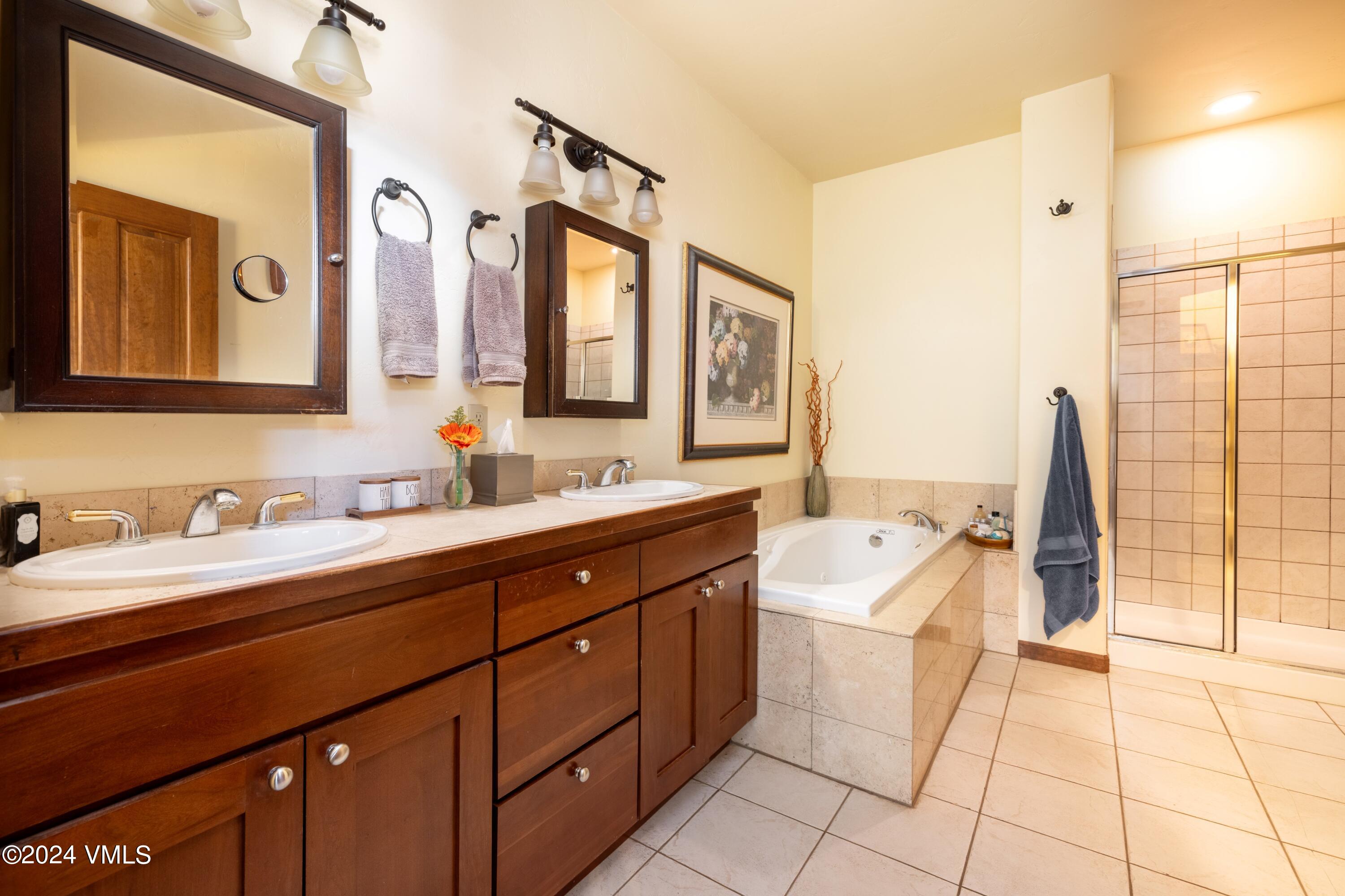 46 Andover Trail, Unit A Edwards, CO 81632 - Photo 8 of 27 a spacious bathroom with a double vanity sink a mirror and a bathtub